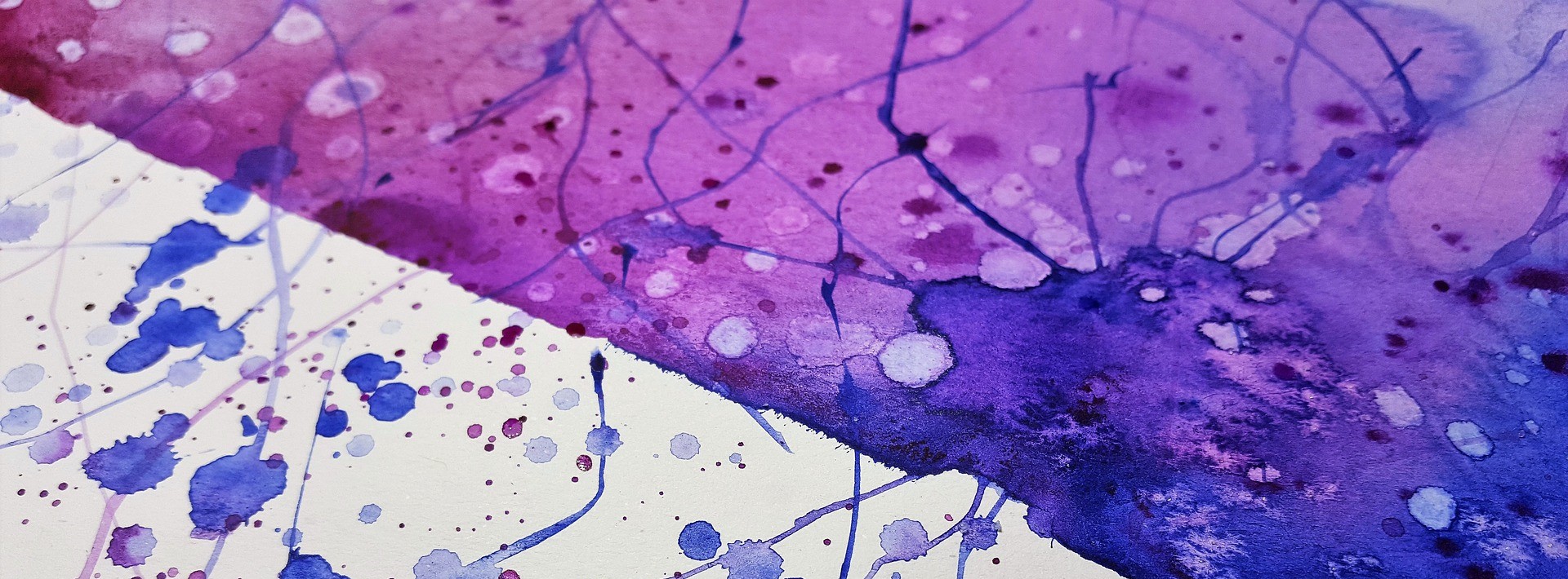 An abstract image of watercolor paint divided by a sharp line